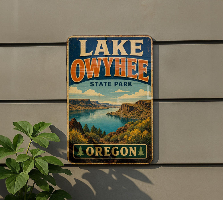 A vintage-style sign for Lake Owyhee State Park in Oregon, featuring a scenic landscape with mountains, water, and greenery.