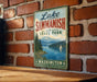 A vintage-style sign for Lake Sammish State Park in Washington, featuring a scenic landscape with a lake, mountains, and a sailboat.