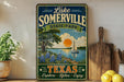 A vintage-style sign for Lake Somerville State Park in Texas, featuring a scenic illustration of a lake, trees, and a sailboat.