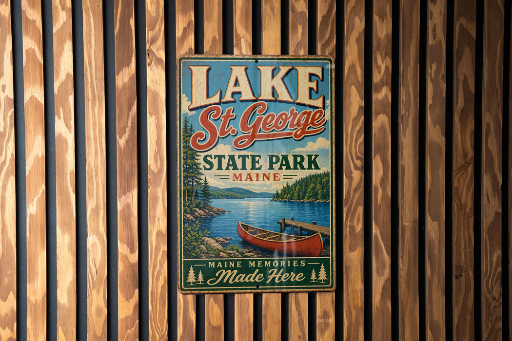 A vintage metal sign for Lake St. George State Park in Maine, featuring a canoe and a scenic landscape.