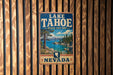 A vintage-style sign for Lake Tahoe, Nevada State Park, mounted on a wooden wall.