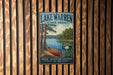 A vintage-style metal sign for Lake Warren State Park, featuring a scenic image of a lake, trees, and a canoe.