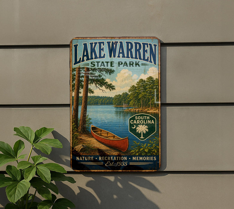 A vintage-style sign for Lake Warren State Park, featuring a scenic image of a lake, trees, and a canoe, mounted on a wall.