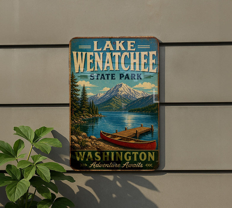 A vintage-style metal sign for Lake Wenatchee State Park in Washington, featuring a scenic illustration of a lake, mountains, and a canoe.
