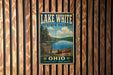 A vintage-style metal sign for Lake White State Park, featuring a scenic image of a lake with a canoe, mounted on a wooden wall.