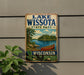 A vintage metal sign for Lake Wissota State Park in Wisconsin, featuring a scenic illustration of a lake, canoe, and surrounding landscape.