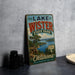 A vintage-style sign for Lake Wister State Park in Oklahoma, featuring a scenic landscape with a lake and mountains.
