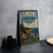 A vintage-style metal sign for Lamoine State Park in Maine, featuring a scenic landscape with pine trees, rocks, and a body of water.