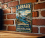 A vintage-style metal sign for Larabee State Park, featuring a scenic landscape with a tree and mountains in the background.