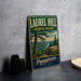 A vintage-style metal sign for Laurel Hill State Park in Pennsylvania, featuring a scenic landscape with a river and pine trees.