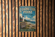 A vintage-style metal sign for Leadbetter Point State Park in Washington, featuring a lighthouse and a scenic beach landscape.