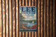 A vintage metal sign for Lee State Park in South Carolina, featuring a scenic illustration of a lake, a pier, and a sailboat.