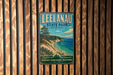 A vintage-style metal sign for Leelau State Park, Michigan, featuring a scenic landscape with a lake, mountains, and pine trees.