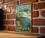 A vintage-style metal sign for Leesville State Park in Virginia, featuring a scenic landscape with a lake, trees, and a bird.