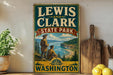 A vintage-style sign for Lewis and Clark State Park in Washington, featuring a scenic illustration of the park's landscape.