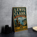 A vintage-style sign for Lewis and Clark State Park in Washington, featuring a scenic illustration of the park's landscape.
