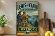 A vintage-style metal sign for the Lewis and Clark State Recreation Site in Oregon, featuring two hikers on a trail overlooking a scenic landscape.