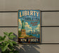 A vintage-style metal sign with the text "LIBERTY STATE PARK Freedom Awaits" and an illustration of the Statue of Liberty in New Jersey.