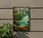 A vintage-style metal sign for Lignum Vitae Key, a botanical state park in Florida, featuring a seagull and a tropical landscape.