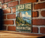 A vintage-style metal sign for Lincoln Rock State Park in Washington, featuring a scenic landscape with mountains, forests, and a lake.