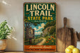 A vintage-style sign for the Lincoln Trail State Park in Illinois, featuring a scenic illustration of a trail surrounded by nature.