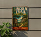 A vintage metal sign for Lincoln Trail State Park in Illinois, featuring a scenic illustration of a trail surrounded by nature.