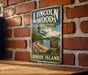 A vintage-style metal sign for Lincoln Woods State Park in Rhode Island, featuring a scenic landscape with a lake, trees, and a sign indicating the park's name.