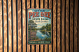 A vintage metal sign for Little Pee Dee State Park in South Carolina, featuring a scenic illustration of a lake, trees, and a bird.