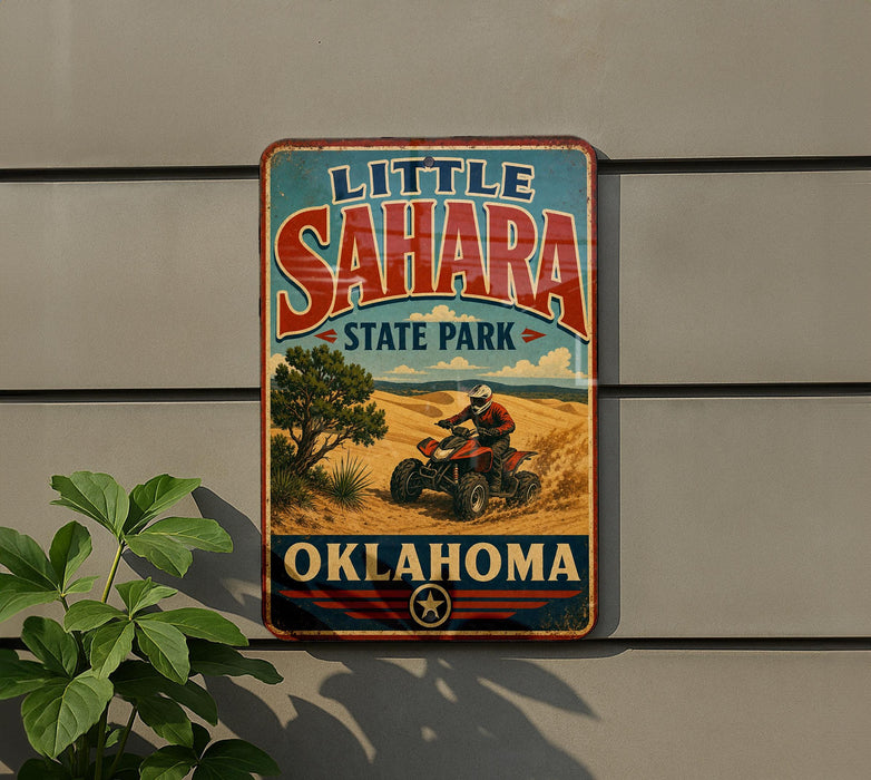 A vintage-style metal sign for Little Sahara State Park in Oklahoma, featuring an illustration of a person riding an ATV in a desert landscape.