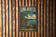 A vintage metal sign for Long Hunter State Park in Tennessee, featuring a scenic illustration of a lake, trees, and a sailboat.