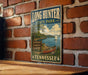 A vintage-style metal sign for Long Hunter State Park in Tennessee, featuring a scenic illustration of a lake, trees, and a boat.