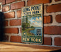 A vintage metal sign for Long Point State Park on Lake Chautauqua, featuring a scenic illustration of the park and its surroundings.