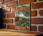 A vintage-style sign for Long Pond Ironworks State Park in New Jersey, featuring a brick wall and a river scene.