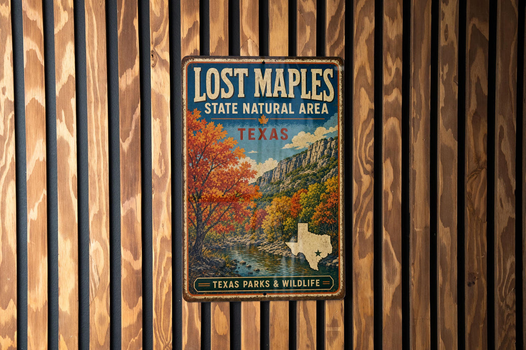 A vintage-style metal sign for Lost Maples State Natural Area in Texas, featuring a scenic landscape with trees and a river.