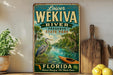 A vintage-style metal sign for Lower Wekiva River Preserve, Florida, featuring a seagull, canoe, and palm trees.