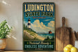 A vintage-style metal sign for Ludington State Park, Michigan, featuring a lighthouse and a scenic landscape.