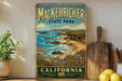 A vintage-style metal sign for Macker richer State Park in California, featuring a scenic coastal landscape with rocky cliffs, a beach, and a blue sky with clouds.