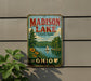 A vintage-style metal sign for Madison Lake State Park in Ohio, featuring a scenic landscape with a lake, trees, and a sailboat.