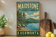 A vintage-style sign for Maidstone State Park in Vermont, featuring a scenic landscape with pine trees, a lake, and mountains.
