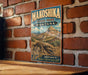 A vintage metal sign for Makoshika State Park in Montana, featuring a dinosaur skeleton and the text "Explore Montana's Wild & Ancient Badlands".