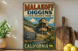A vintage-style sign for Malakoff Diggins State Historic Park in California, featuring an illustration of a gold mining structure and a scenic landscape.