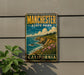 A vintage-style metal sign for Manchester State Park in California, featuring a scenic coastal landscape with cliffs, ocean, and flowers.