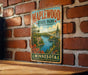 A vintage-style metal sign for Maplewood State Park in Minnesota, featuring a scenic landscape with a lake and forest.