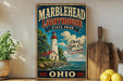 A vintage-style sign for Marblehead Lighthouse State Park, featuring a lighthouse and a scenic landscape.