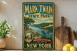A vintage-style sign for Mark Twain State Park in New York, featuring a scenic landscape with a river, mountains, and a steamboat.