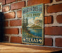 A vintage-style metal sign for Martin Dies Jr. State Park in Texas, featuring a scenic landscape with a lake and mountains.