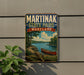 A vintage-style sign for Martinak State Park, Maryland, featuring a scenic image of a lake with a canoe, surrounded by trees and mountains.