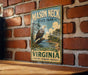 A vintage-style metal sign for Mason Neck State Park in Virginia, featuring an eagle perched on a tree branch and the text "Mason Neck State Park" prominently displayed.