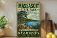 A vintage-style metal sign for Massachusetts State Park, featuring a scenic landscape with pine trees, a lake, and mountains.
