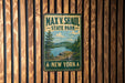 A vintage metal sign for Max V. Shaul State Park in New York, featuring a scenic landscape with a lake and mountains.